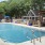 a swimming pool with outdoor kitchen, grilling area