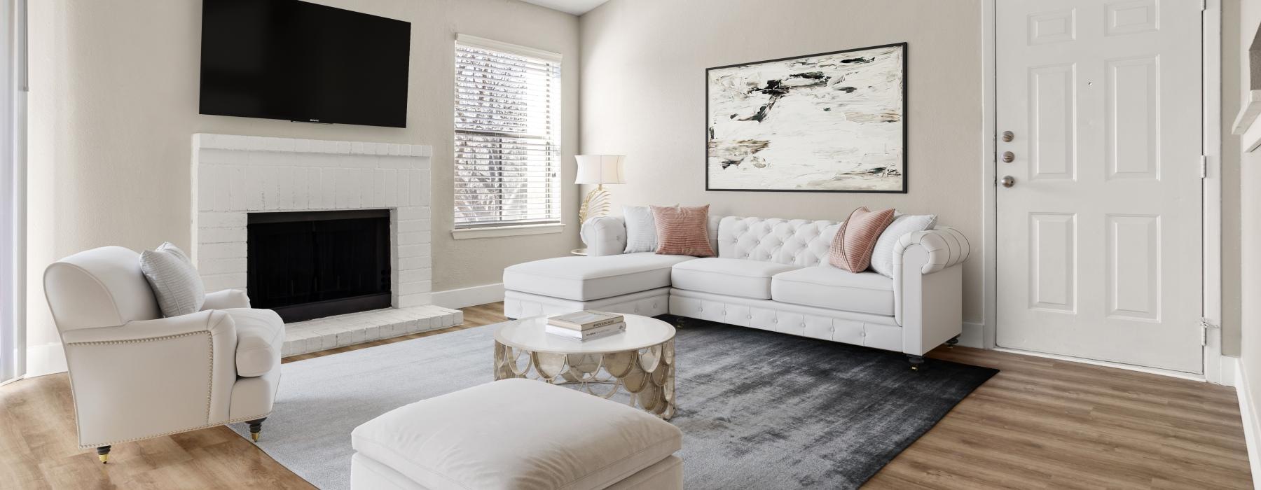 a living room with a fireplace and neutral decor