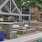 clubhouse exterior with a pool and a deck with a fire pit